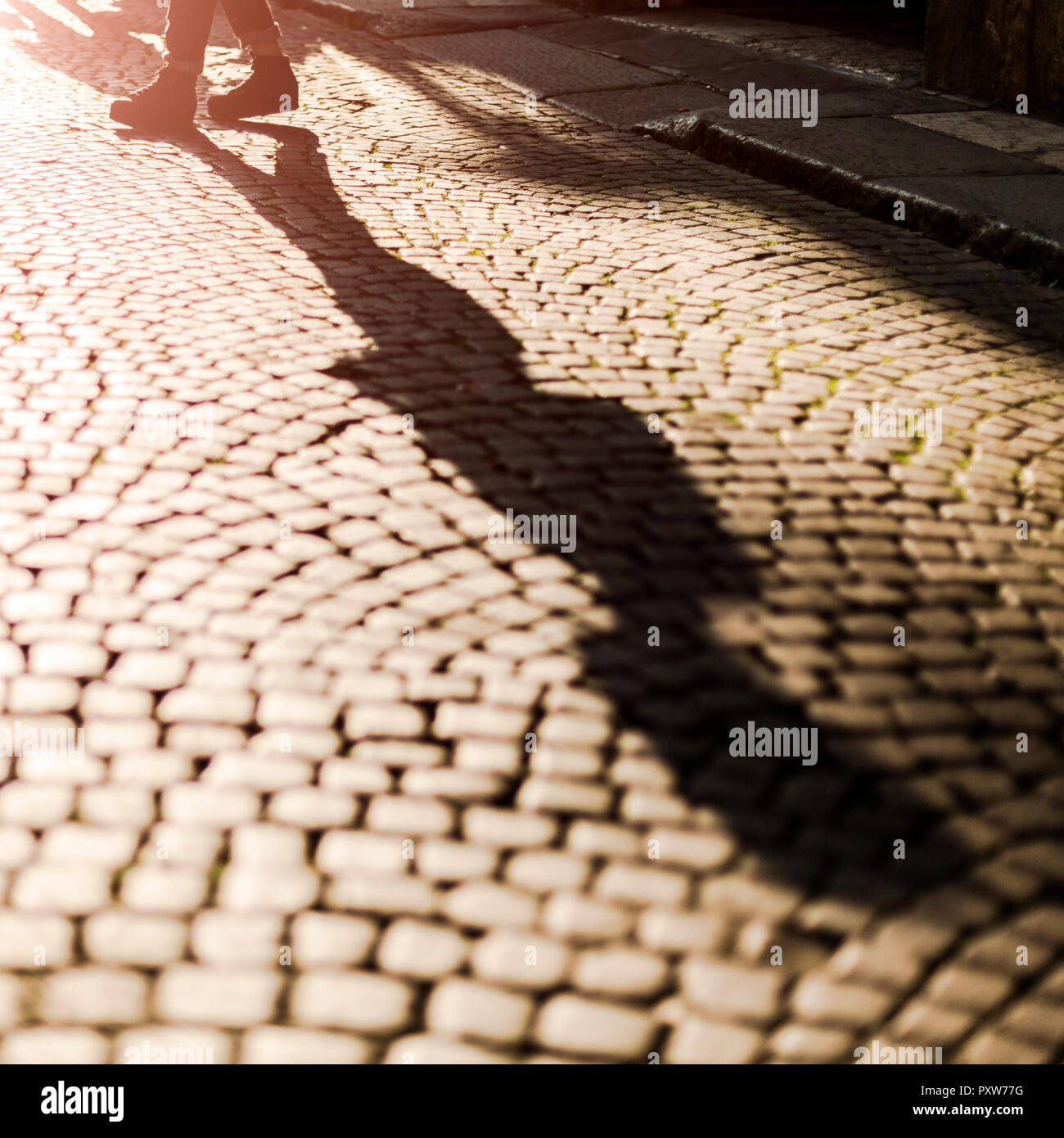 Shadow of woman crossing the street Stock Photo - Alamy
