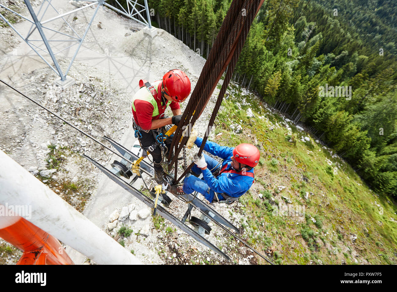 Germany, Bavaria, Garmisch-Partenkirchen, Zugspitze, installers working on goods cable lift Stock Photo