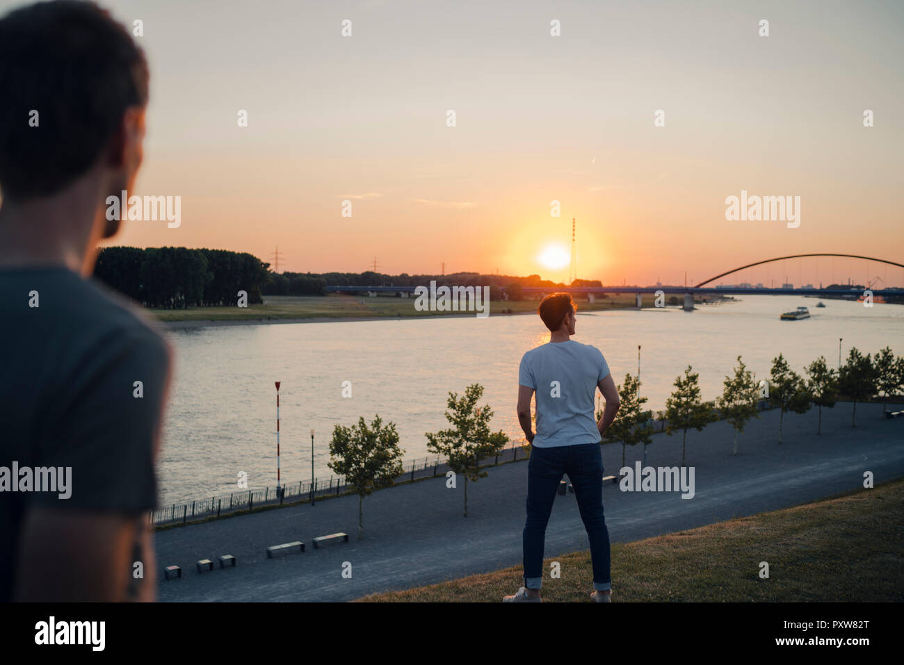 two friends walking in the sunset