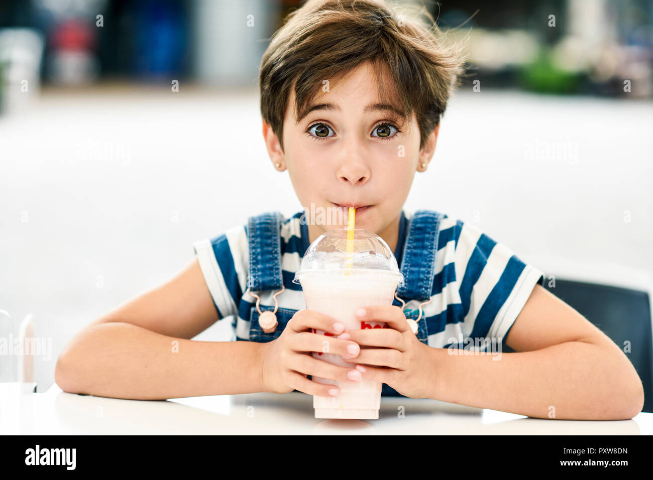 https://c8.alamy.com/comp/PXW8DN/portrait-of-little-girl-drinking-strawberry-milkshake-at-pavement-cafe-PXW8DN.jpg
