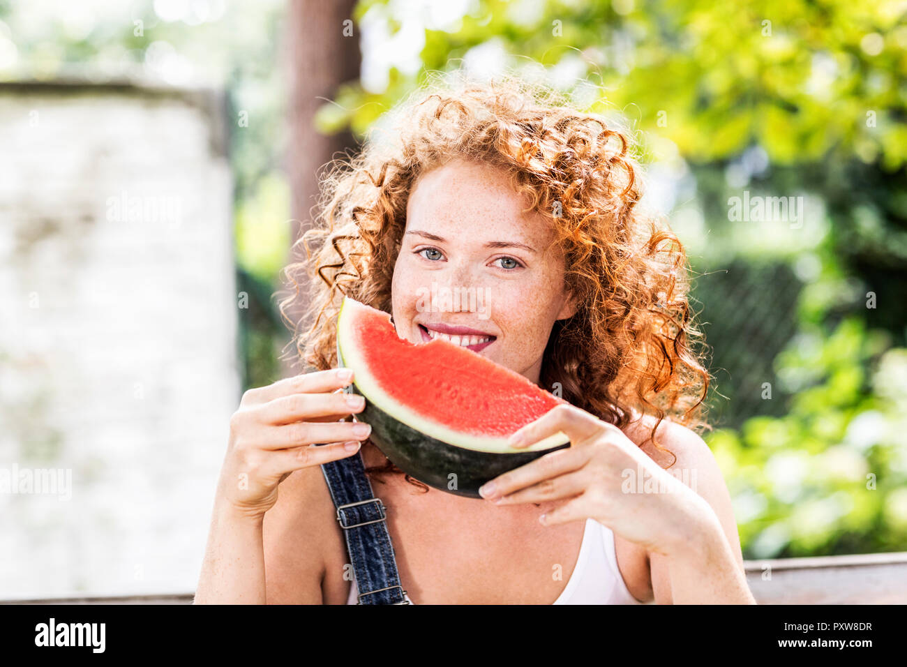 Portrait of redheaded young woman with watermelon Stock Photo