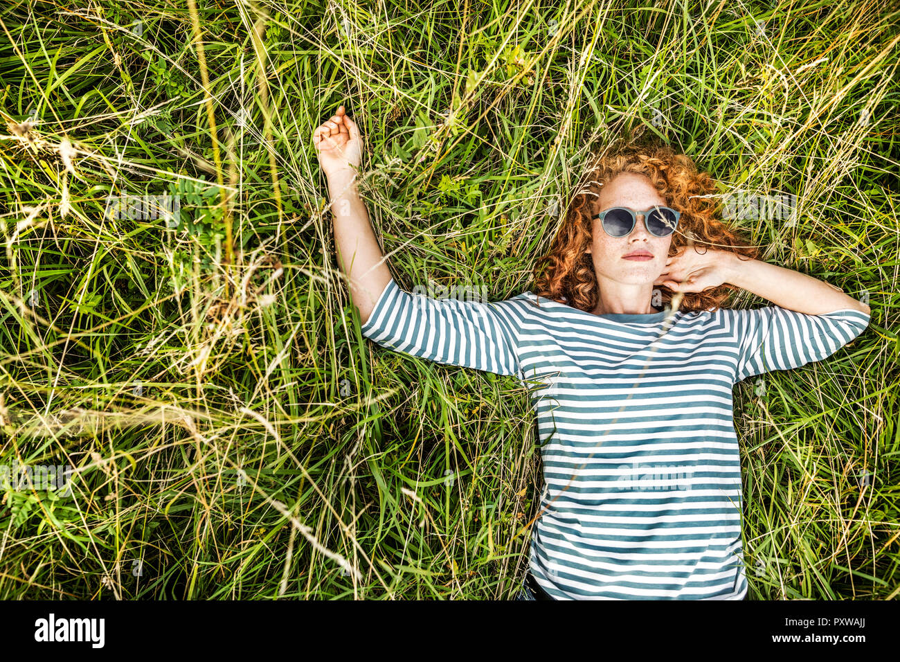 Portrait of young woman relaxing on a meadow Stock Photo
