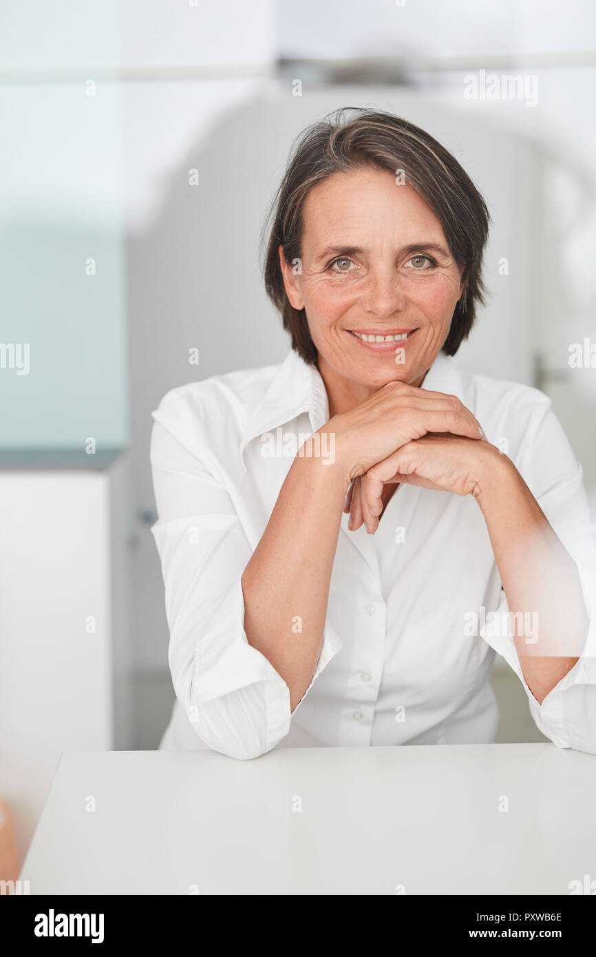 Portrait of mature businesswoman wearing white blouse Stock Photo