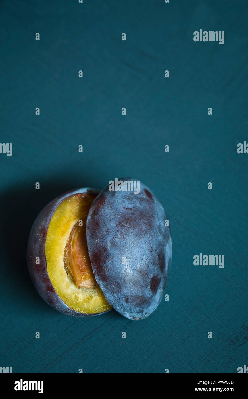 Sliced plum on blue ground Stock Photo