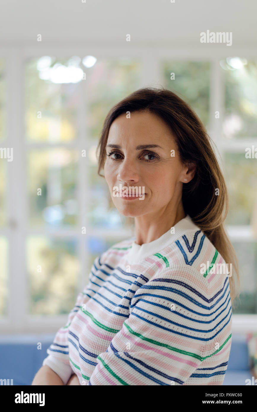 Portrait of confident mature woman at home Stock Photo - Alamy
