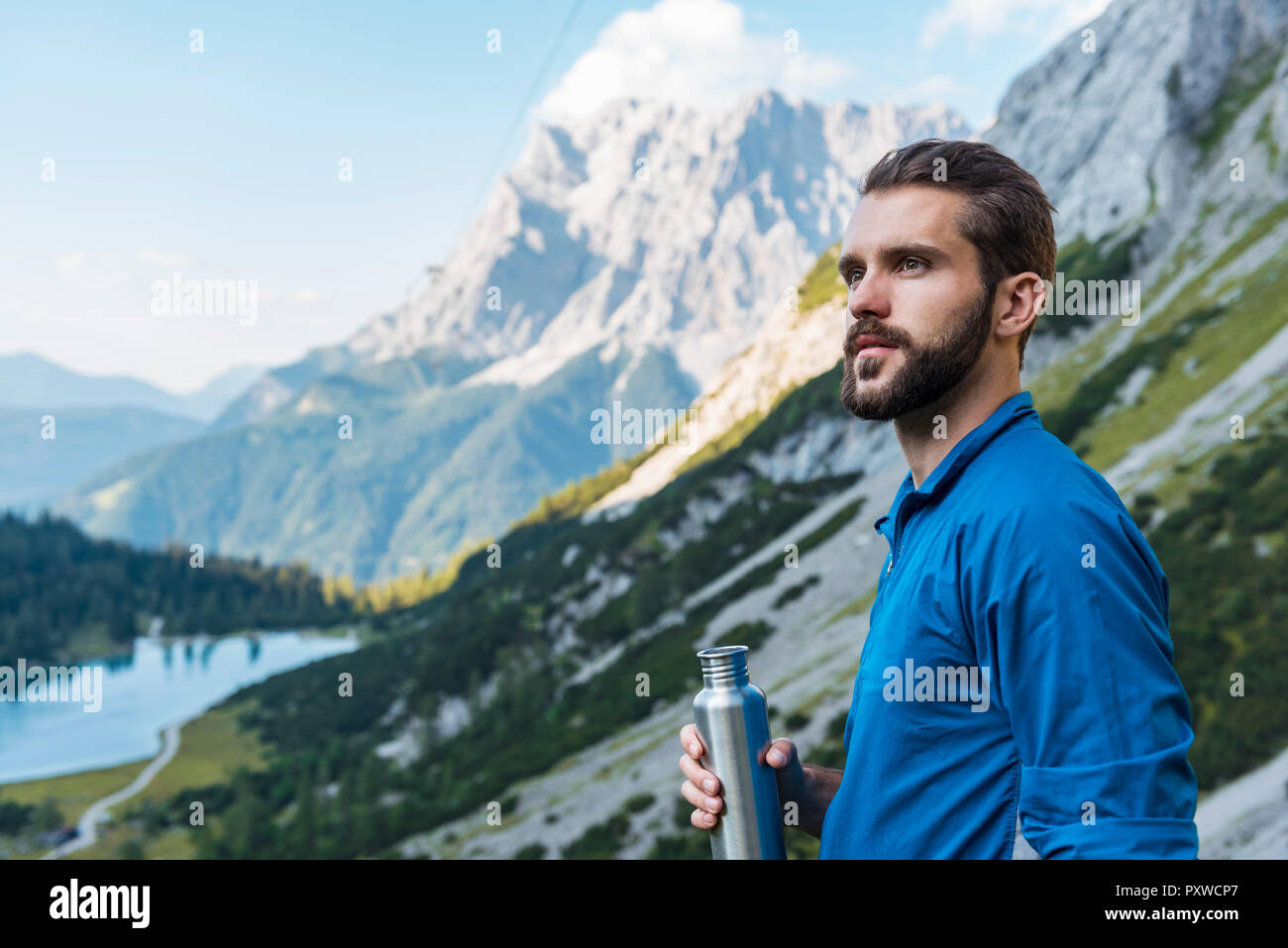 Austria, Tyrol, Hiker taking a break in the mountains at Lake Seebensee Stock Photo