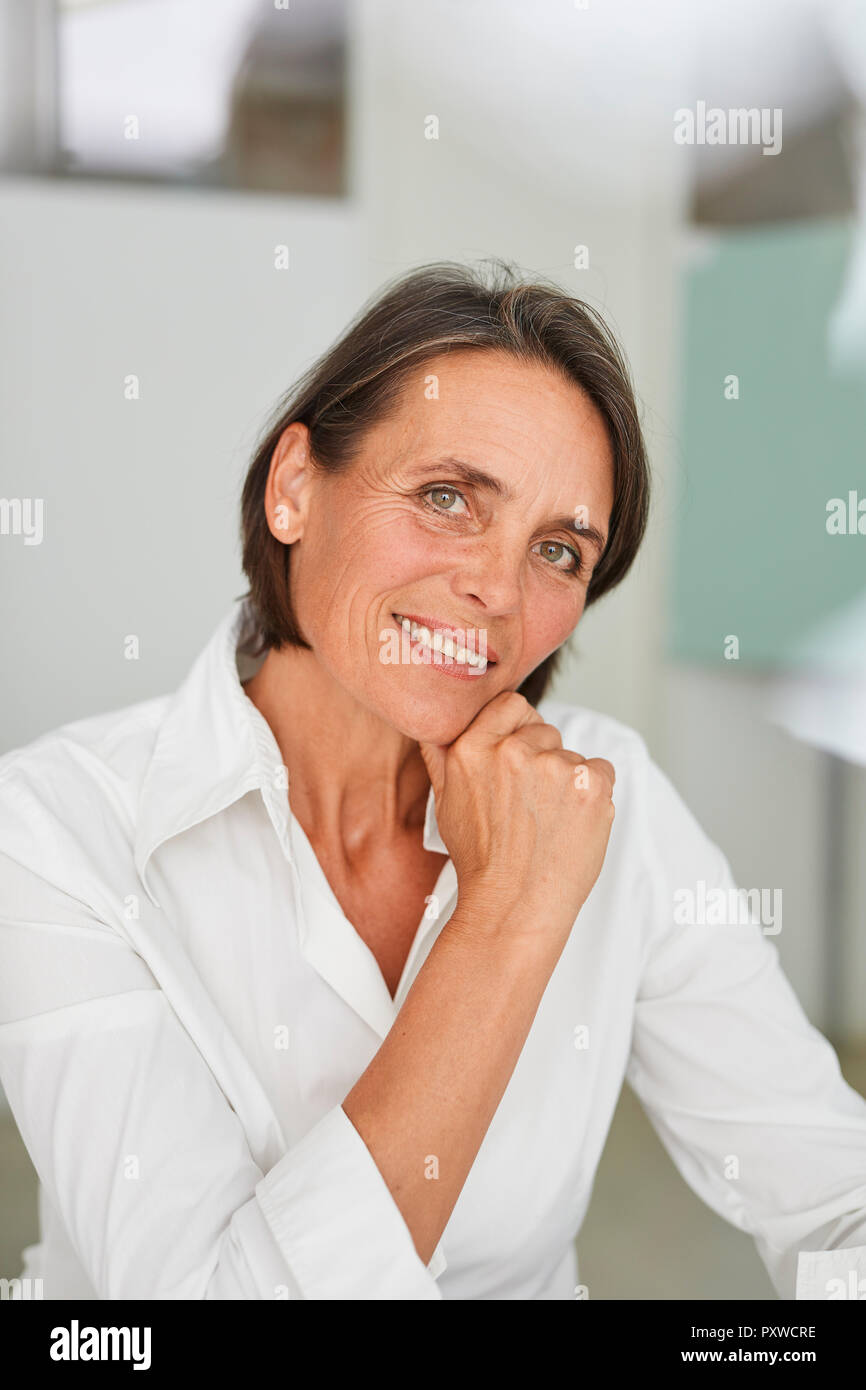 Portrait of mature businesswoman wearing white blouse Stock Photo