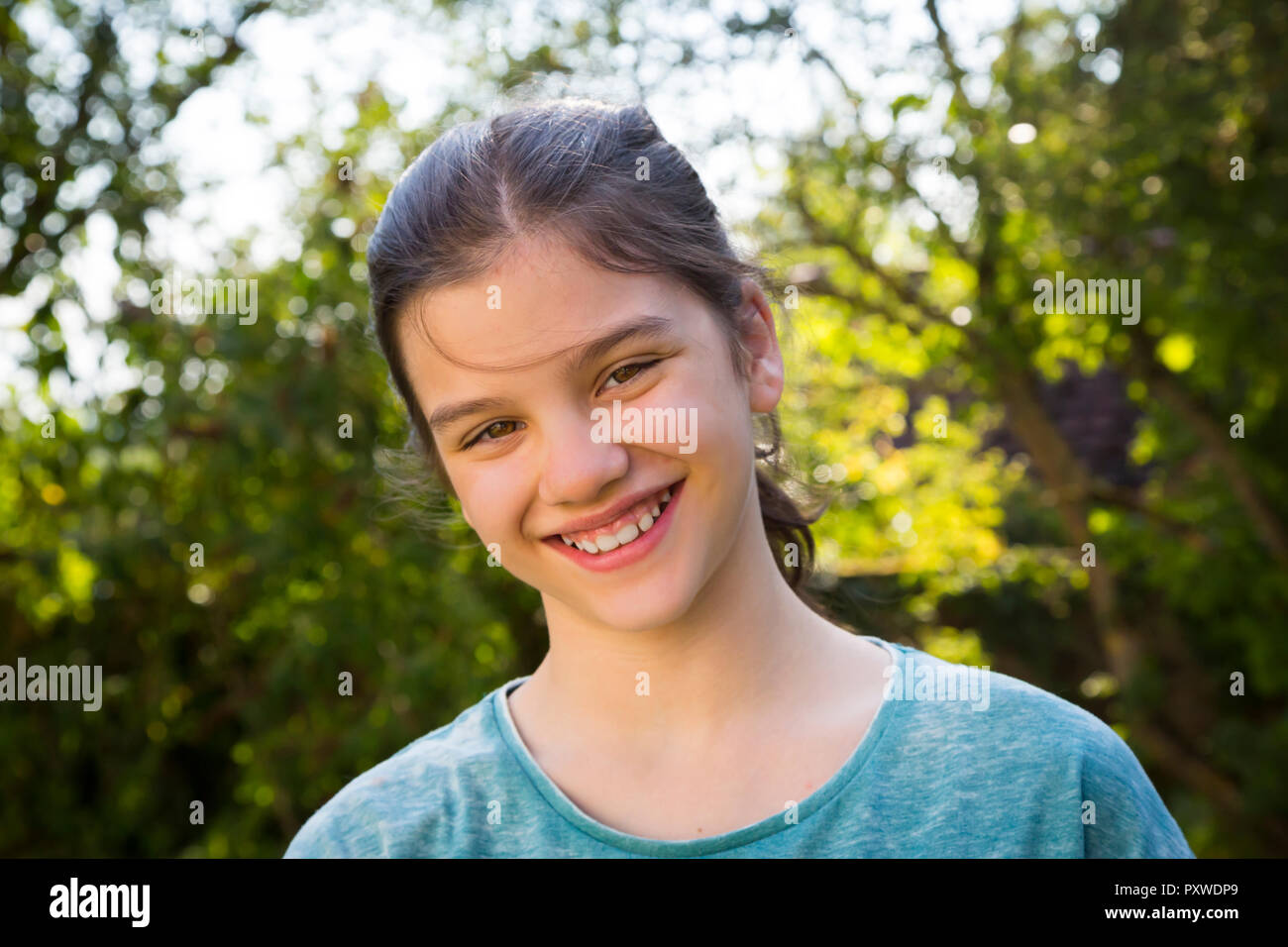 Portrait of smiling girl in the garden Stock Photo - Alamy