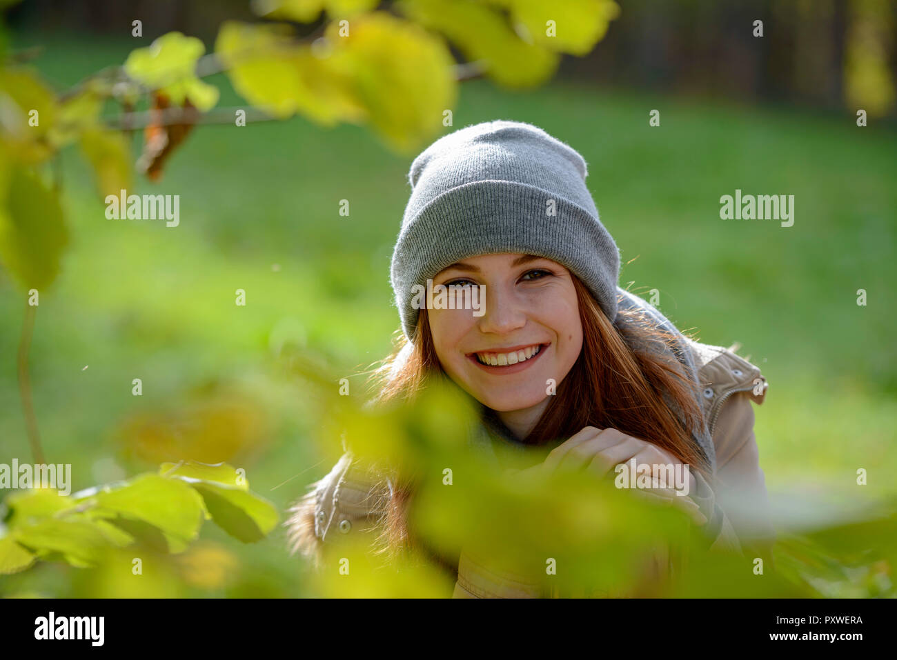 Portrait of smiling teenage girl in autumnal forest Stock Photo - Alamy