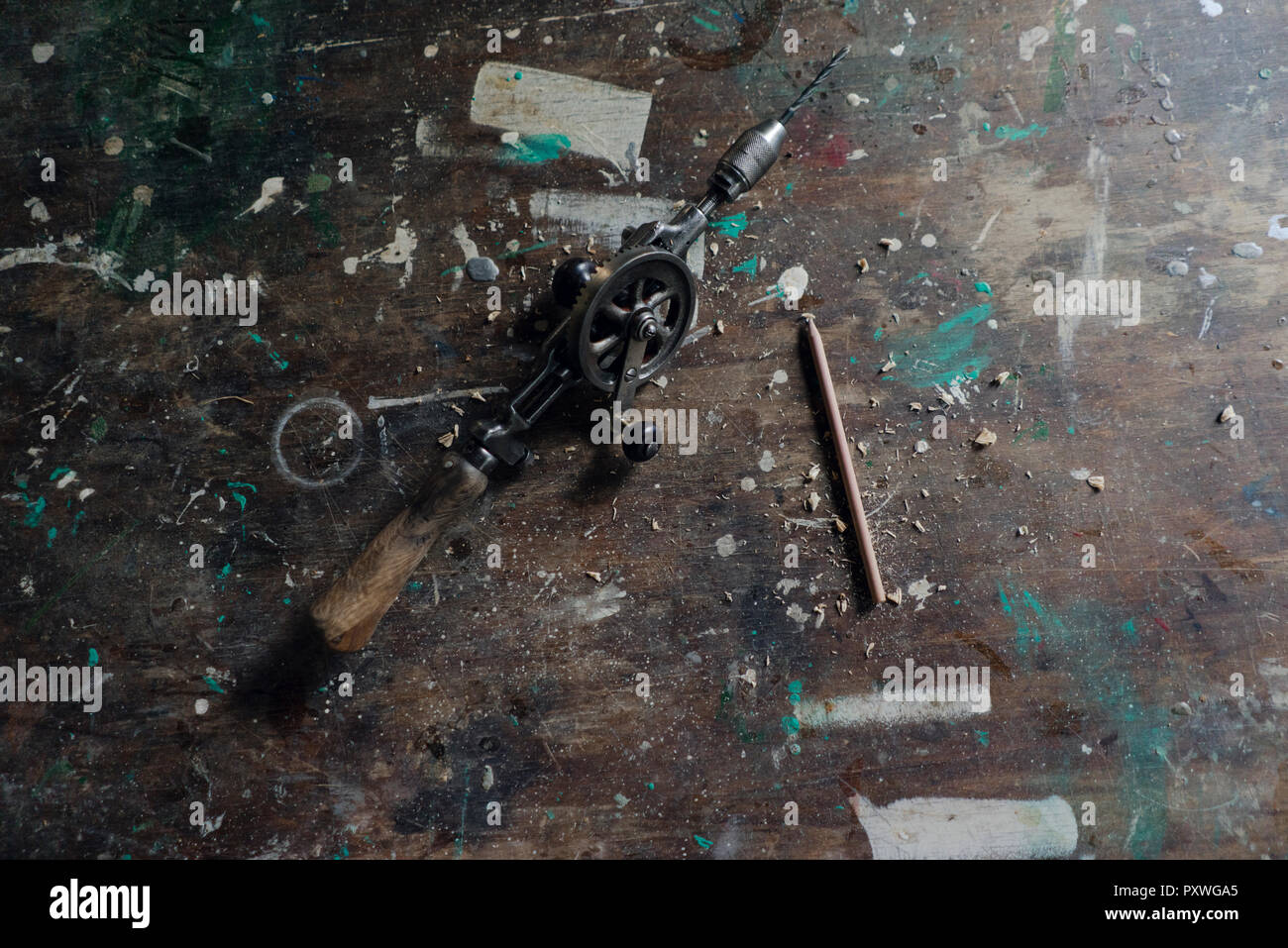 Old hand drill and pencil in workshop Stock Photo