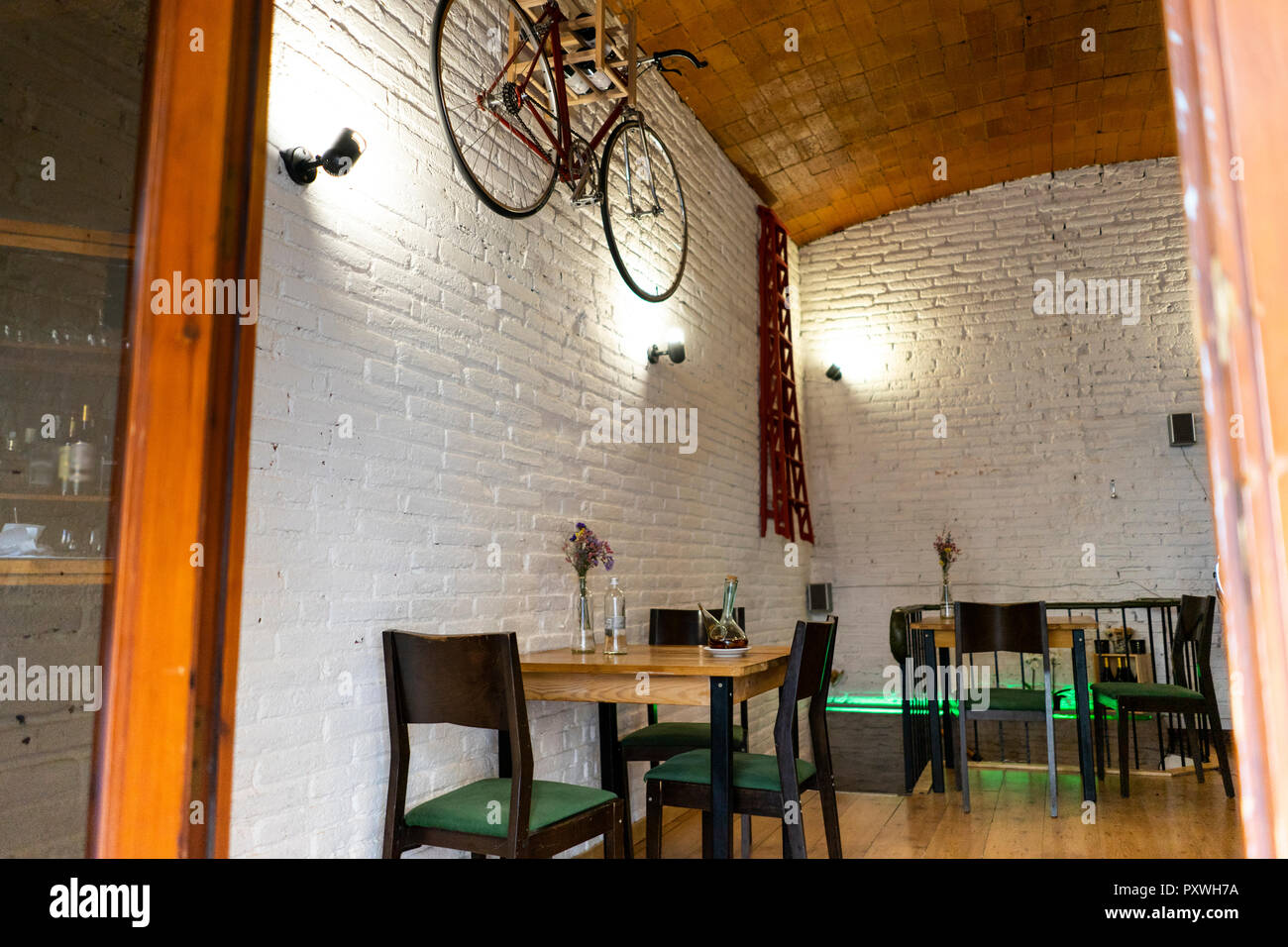 Interior of a restaurant with bicycle hanging on the wall Stock Photo