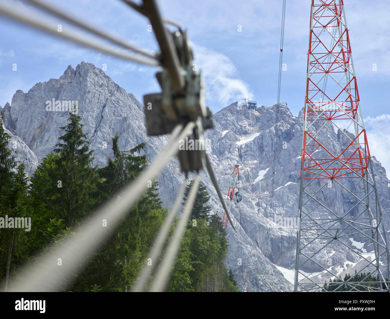 Germany, Bavaria, Garmisch-Partenkirchen, Zugspitze, installers working on poles of a goods cable lift Stock Photo