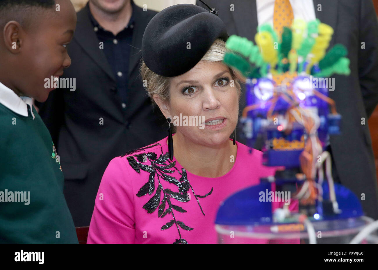 Queen Maxima of the Netherlands reacts as she interacts with school children as they work on the Ohbot, an educational robotics system, at the UK-Netherlands Innovation Showcase at Mansion House in London on the second day of her State Visit to the UK. Stock Photo