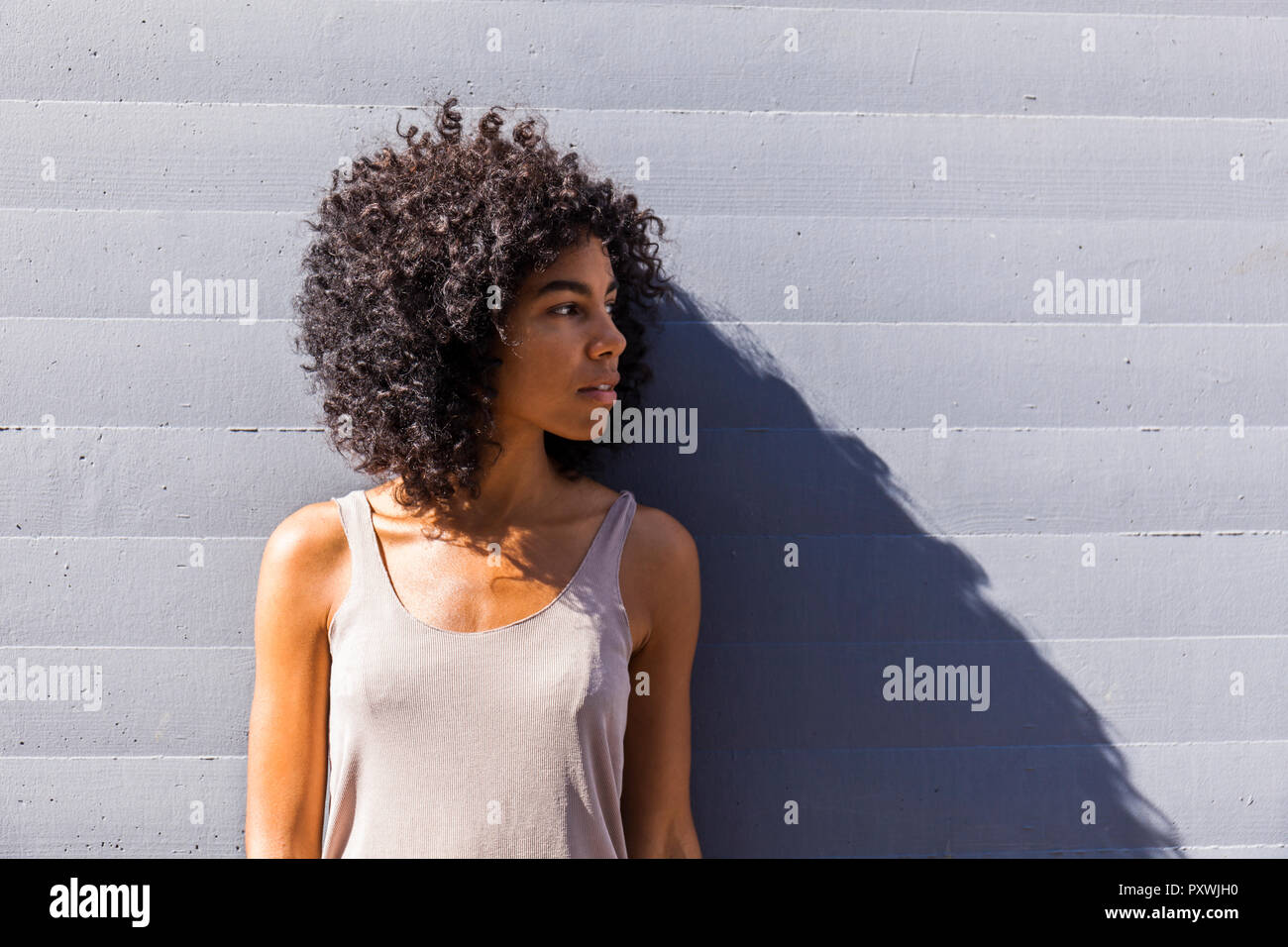 Young woman with curly hair waiting Stock Photo