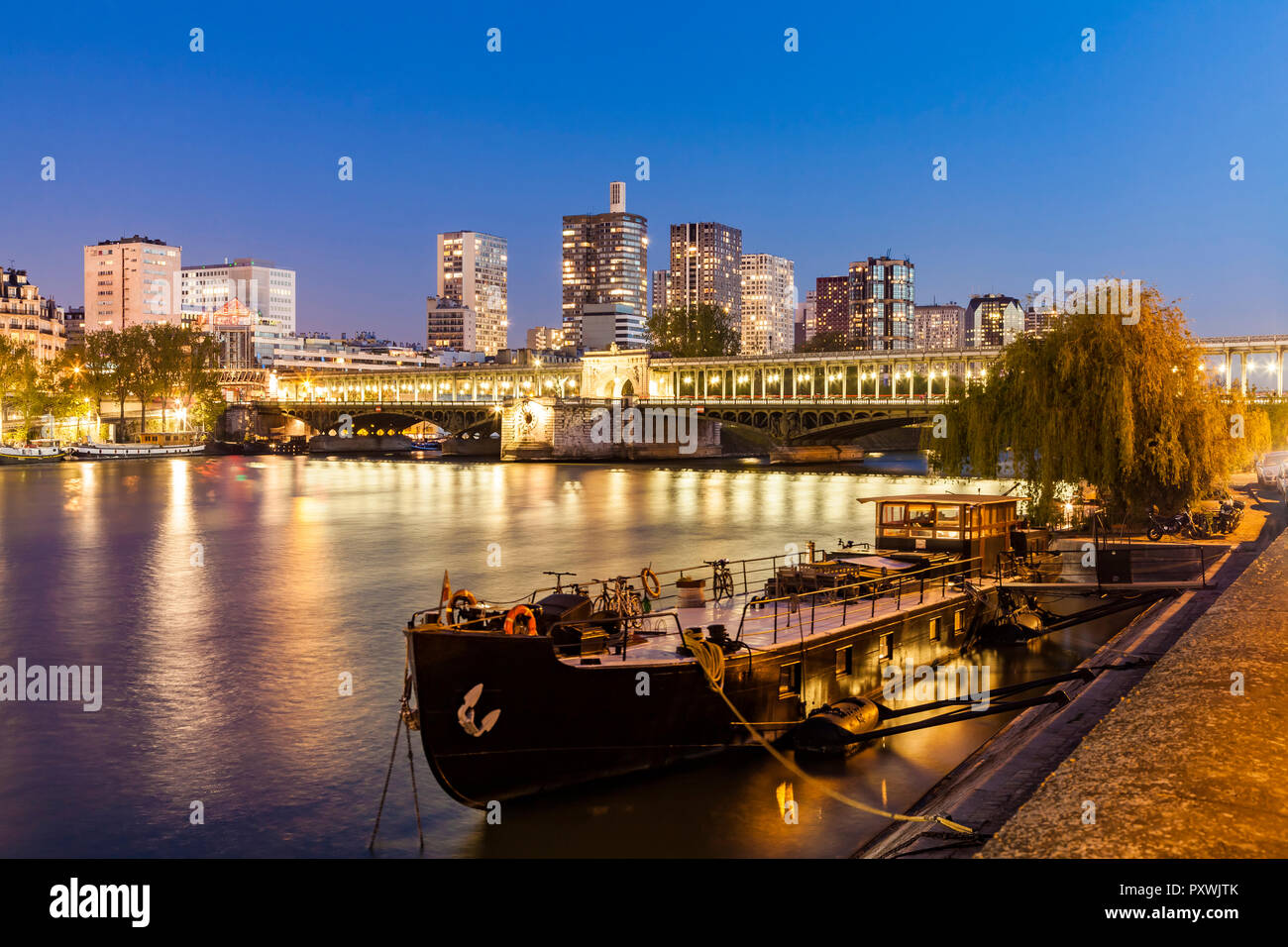 France, Paris, Pont de Bir-Hakeim, Seine river, modern high-rise buildings at blue hour Stock Photo