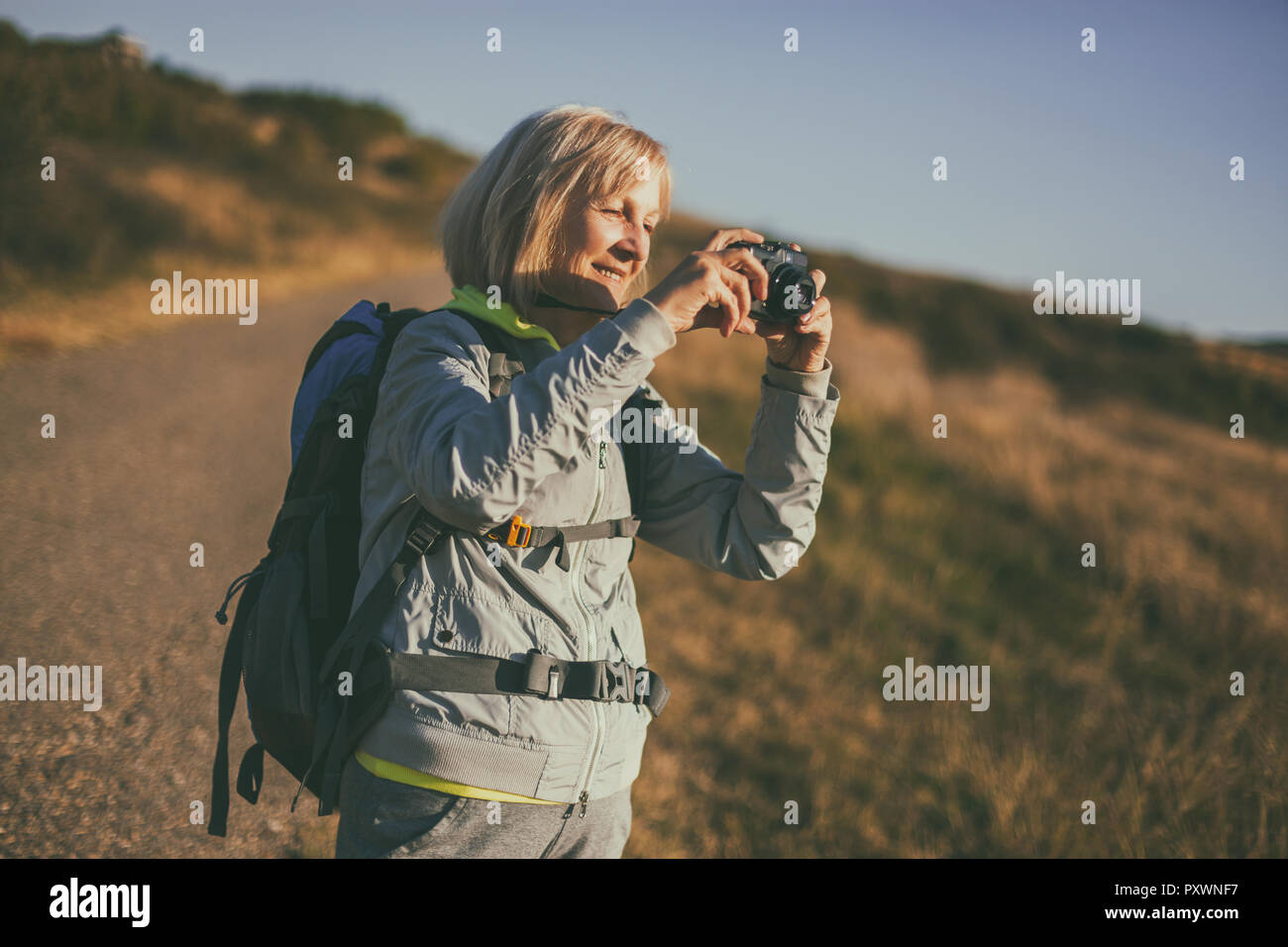 Tourist woman camera hiking hi-res stock photography and images - Alamy