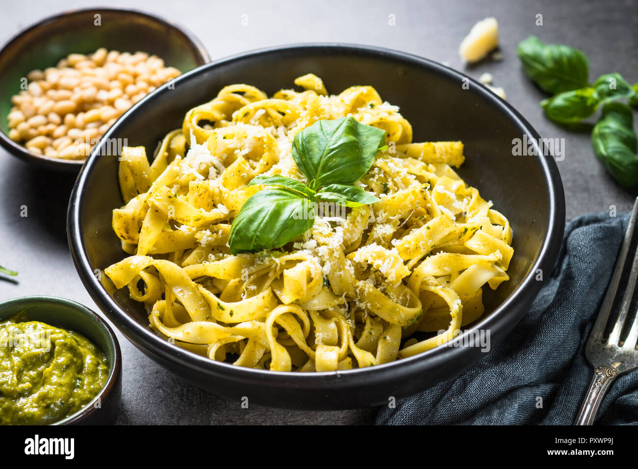Tagliatelle pasta with pesto sauce and parmesan. Stock Photo