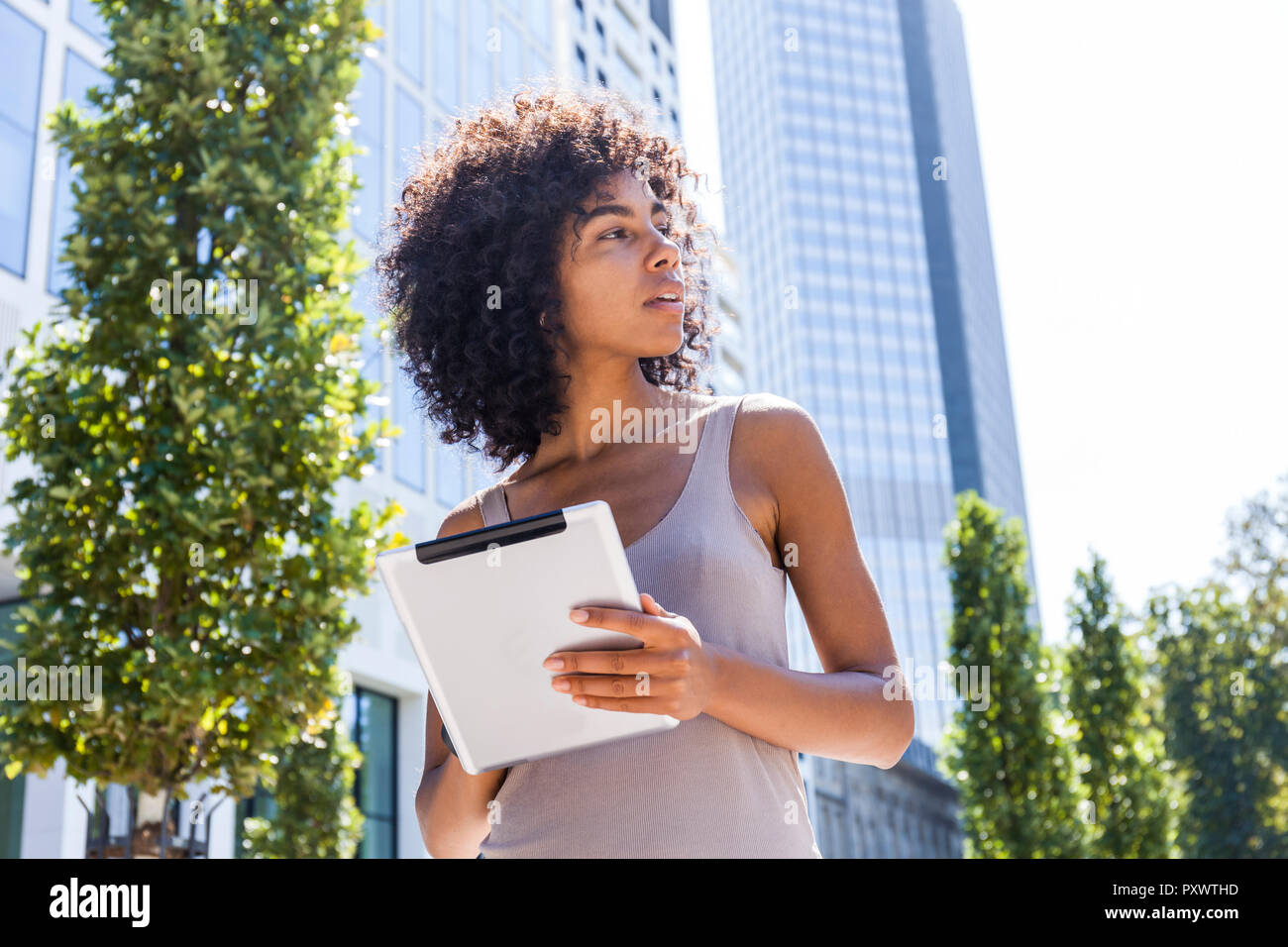 Germany, Frankfurt, young woman with tablet in the city Stock Photo