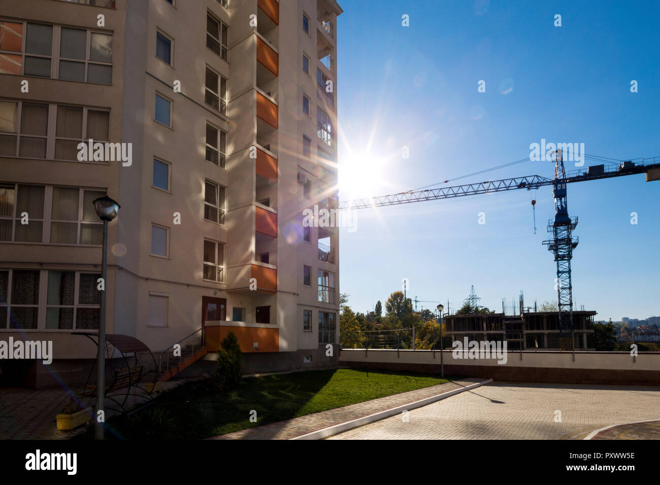 view of residential complexes against the blue sky and the construction ...