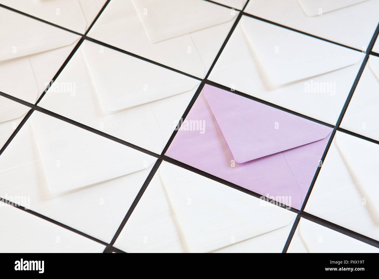 Composition with white and purple envelopes on the table. Different colored envelopes on the table. Stock Photo