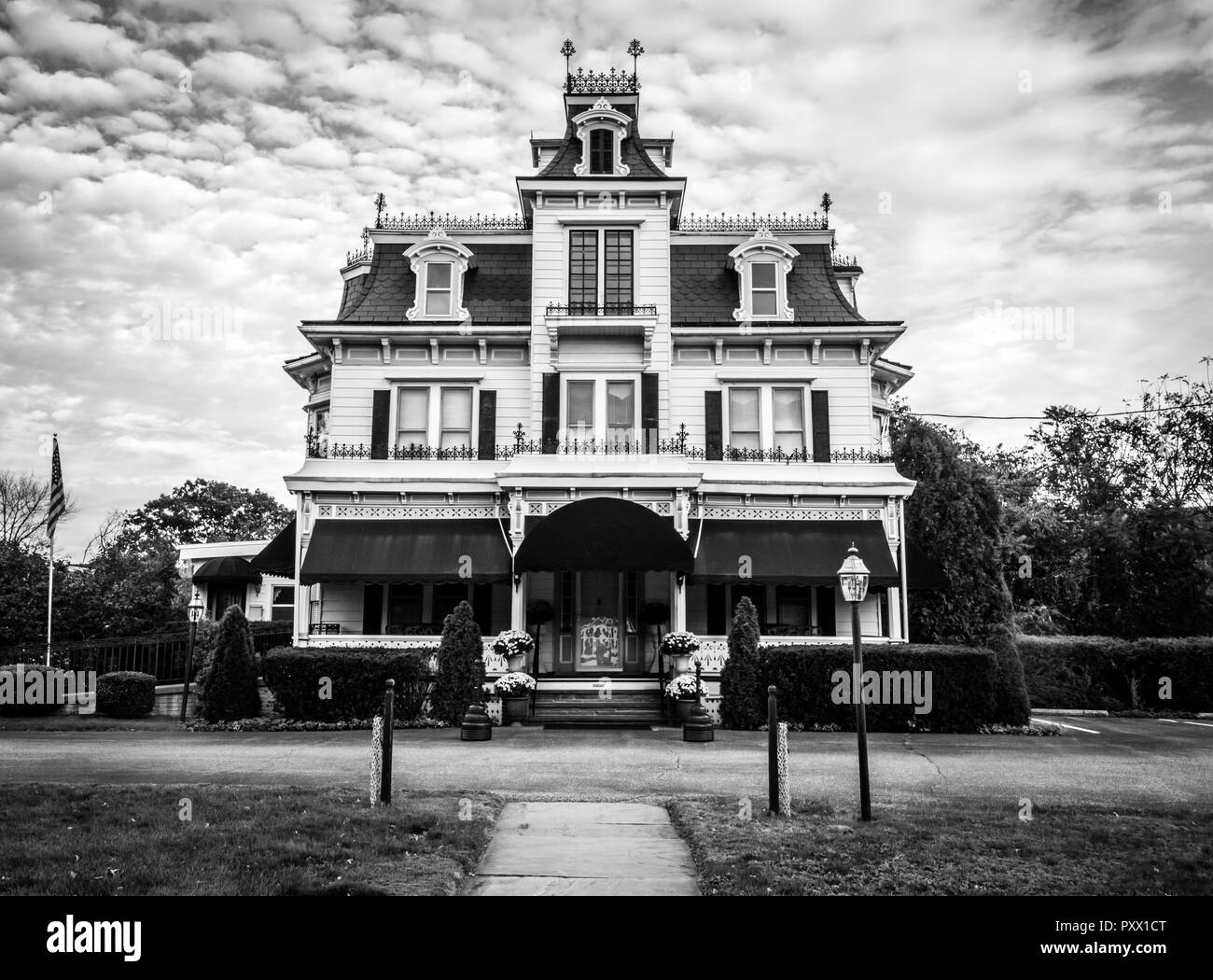 Victorian style funeral home is meticulously maintained and ornate with unique crow's nest in Port Jervis, NY, black and white Stock Photo