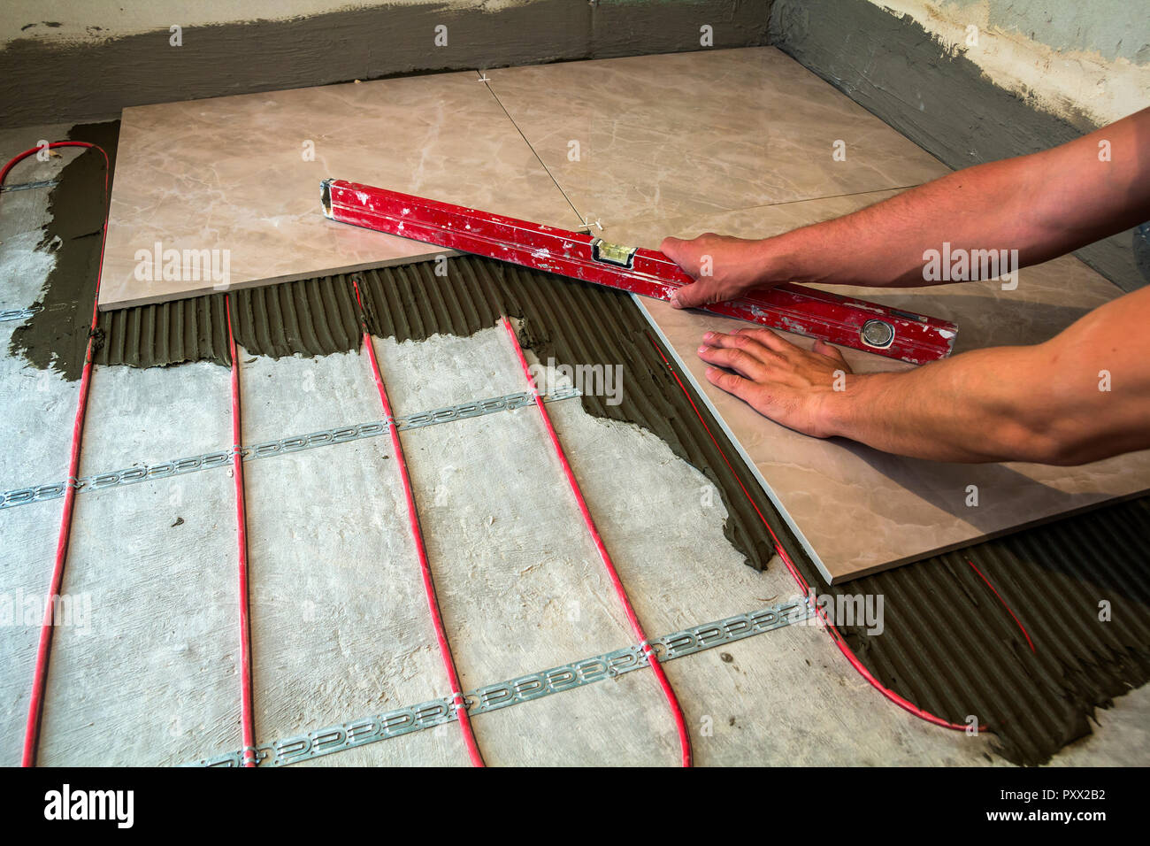 Ceramic Tiles And Tools For Tiler Worker Hand Installing Floor