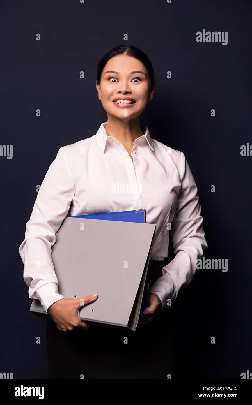 Portrait of young happy smiling business woman with folder Stock Photo ...