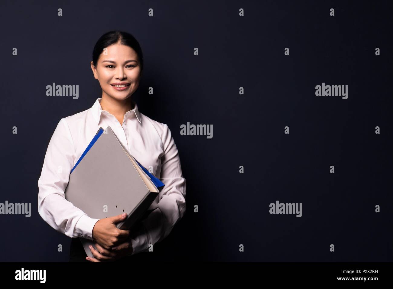 Portrait of young happy smiling business woman with folder Stock Photo ...