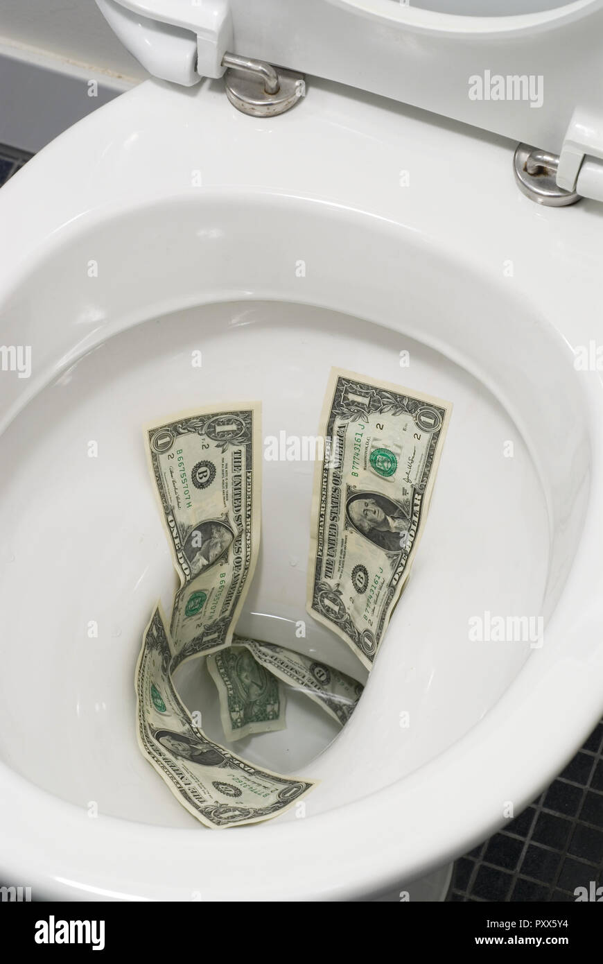 Dollar bills flushed down the toilet Stock Photo - Alamy