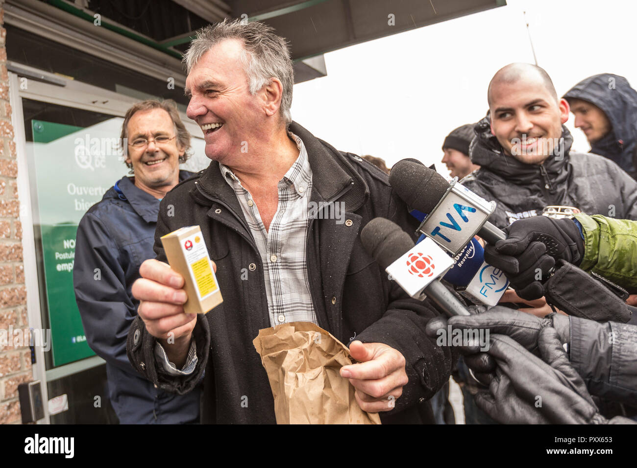 One of the first customers shows to the media the cannabis products he just acquires on the first day of cannabis legalization at a SQDC (Societe quebecoise du cannabis) store in Quebec city, Canada, 17 October 2018. Stock Photo