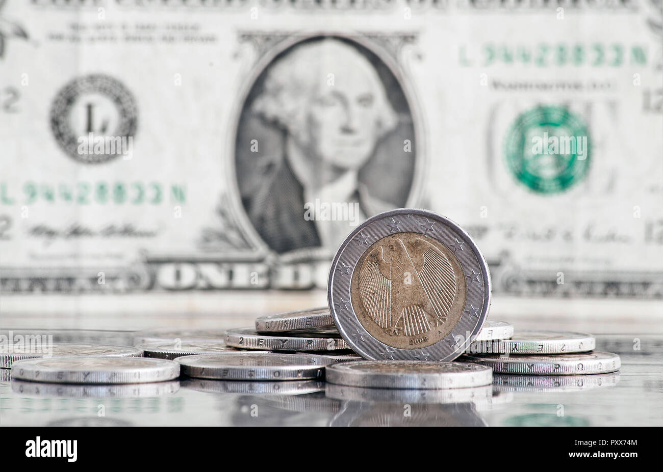 german euro coin with us dollar banknote in background Stock Photo Alamy