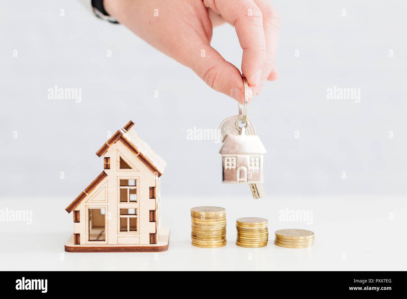 House and person holding keys Stock Photo Alamy