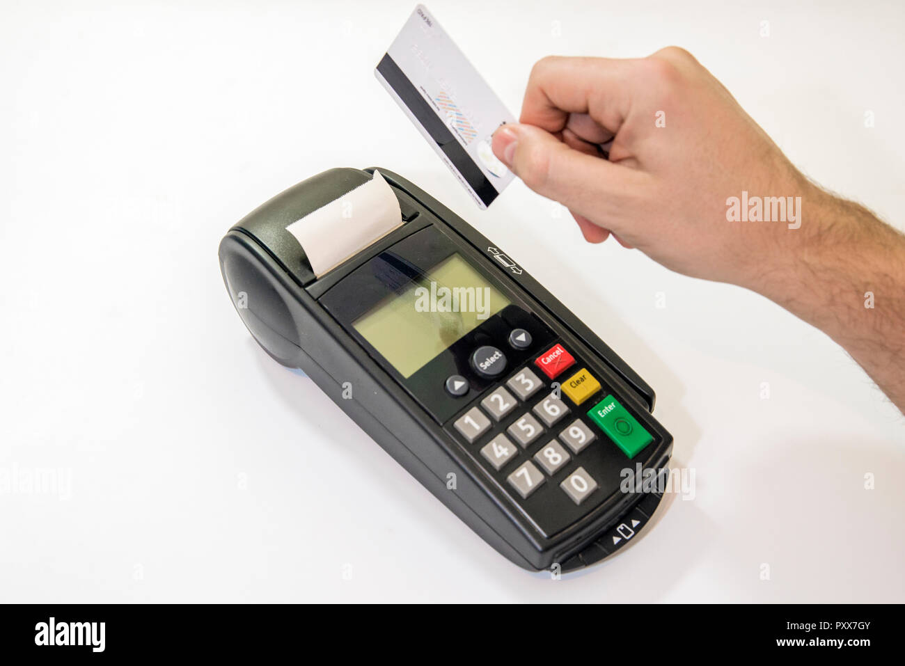 Male hand dials pin code on pin pad of card machine or pos terminal with inserted blank white credit card isolated on white background. Payment with c Stock Photo
