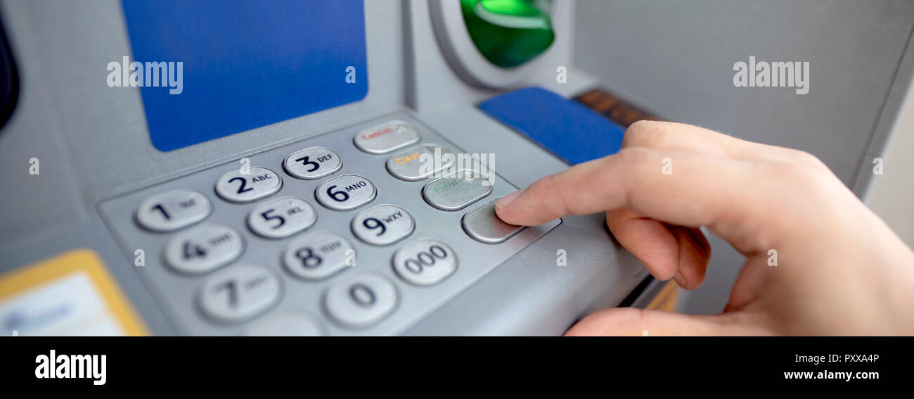 Man entering code on ATM. Close up of keypad. Withdrawing money from an ATM Stock Photo