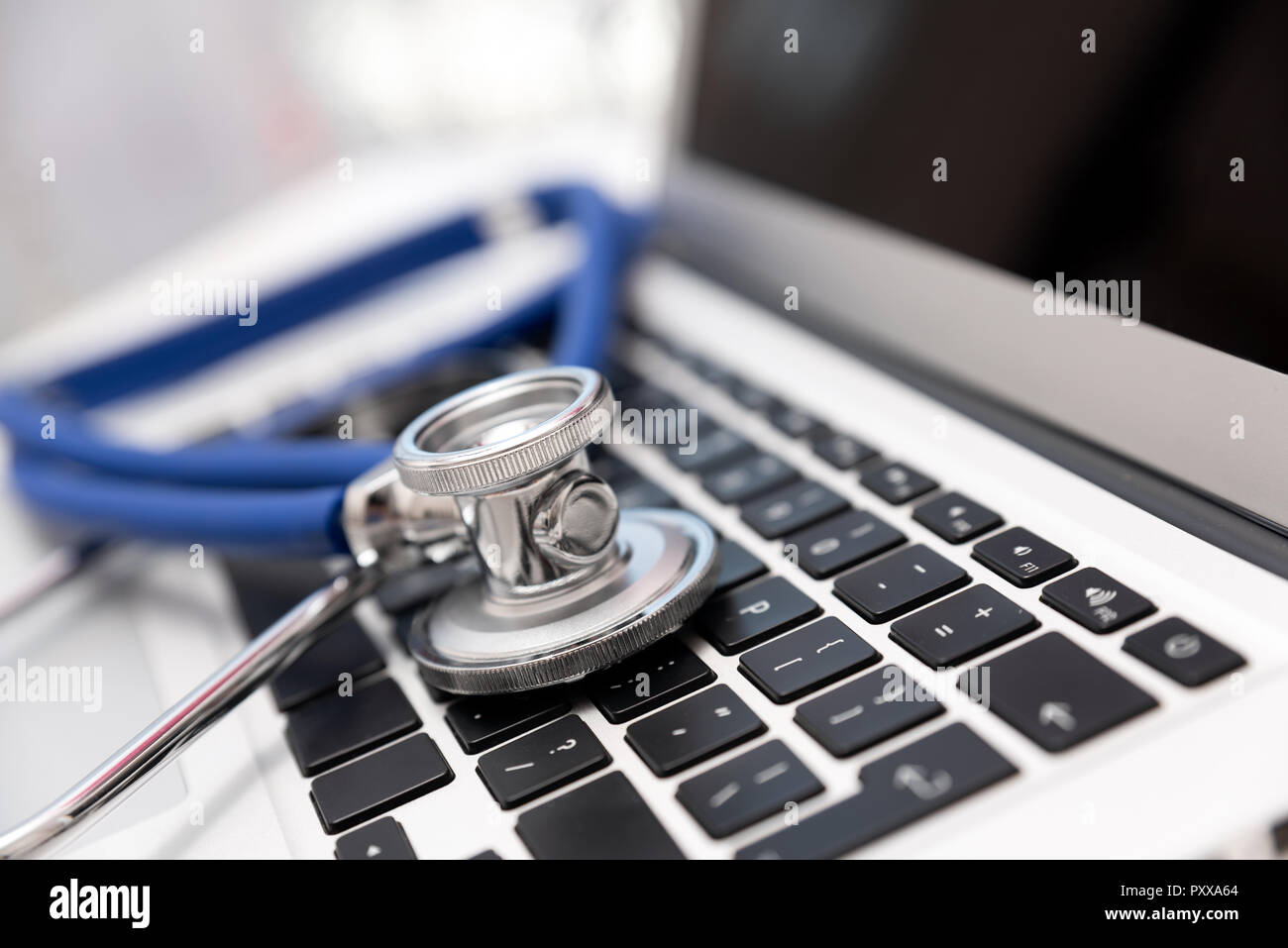 Stethoscope on laptop keyboard. Health care or IT security concept Stock Photo
