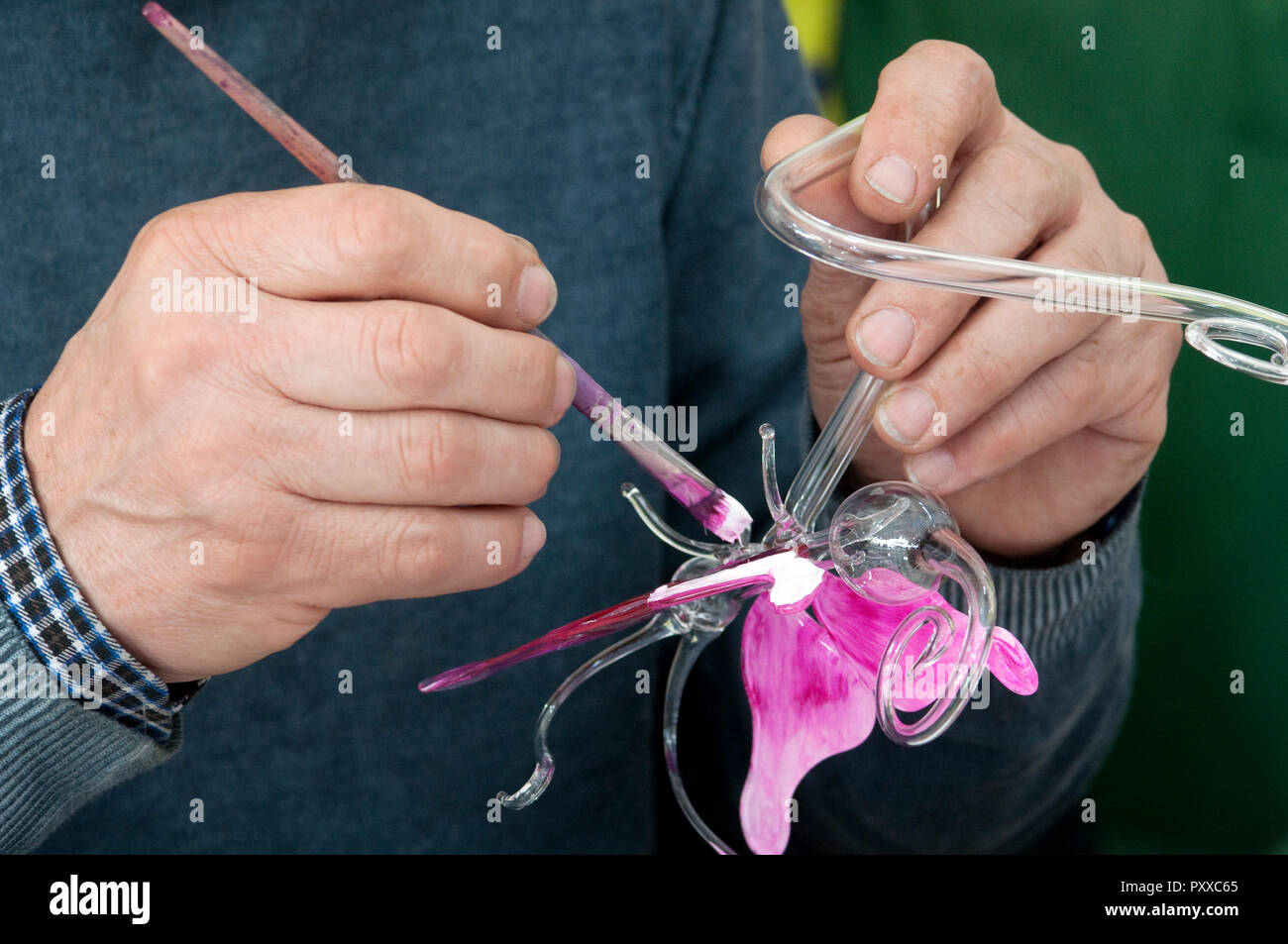 Close-up of Person Painting Butterfly Glass Stock Photo
