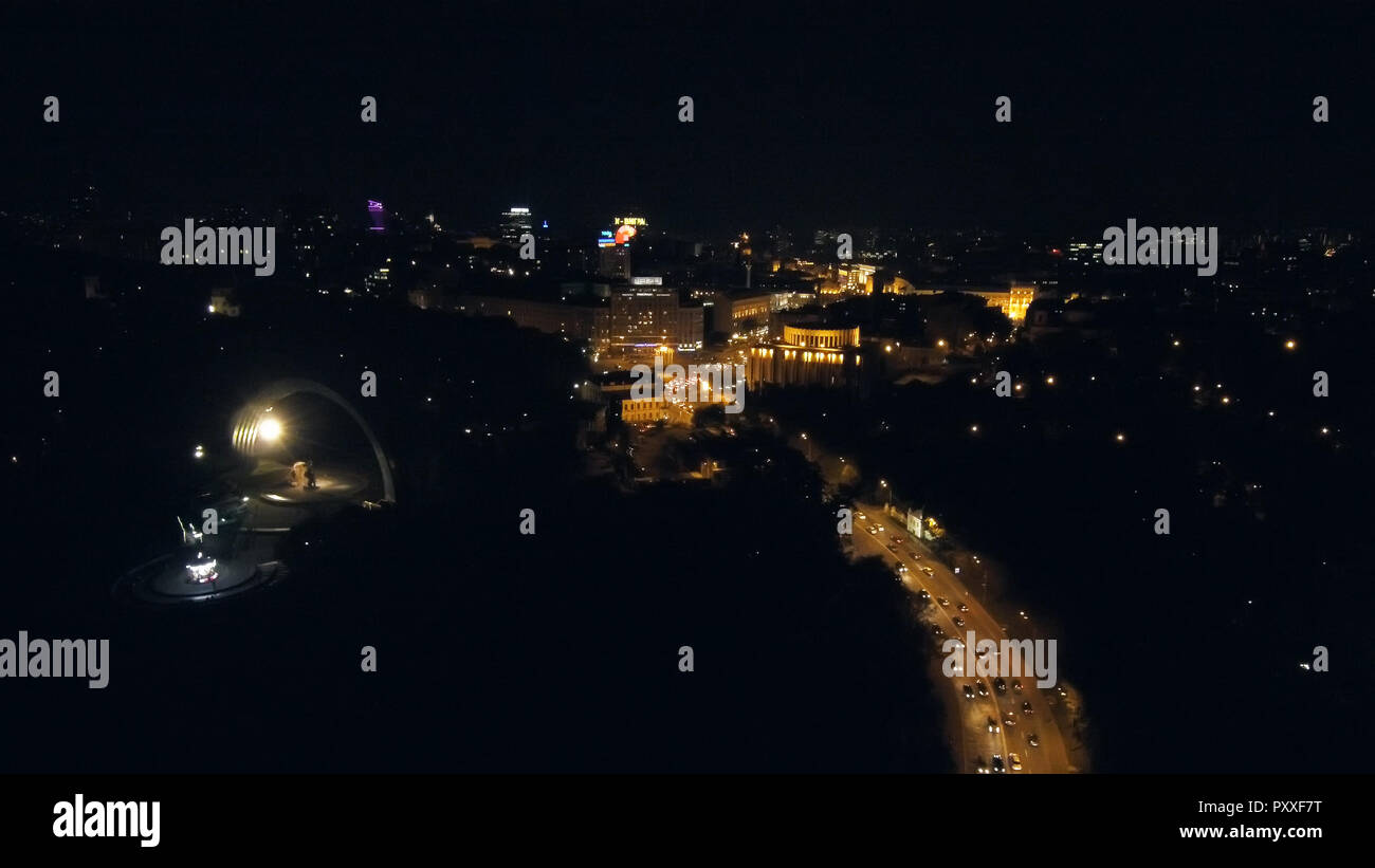Aerial view from Drone: Night city flying over the road and night lights. Stock Photo