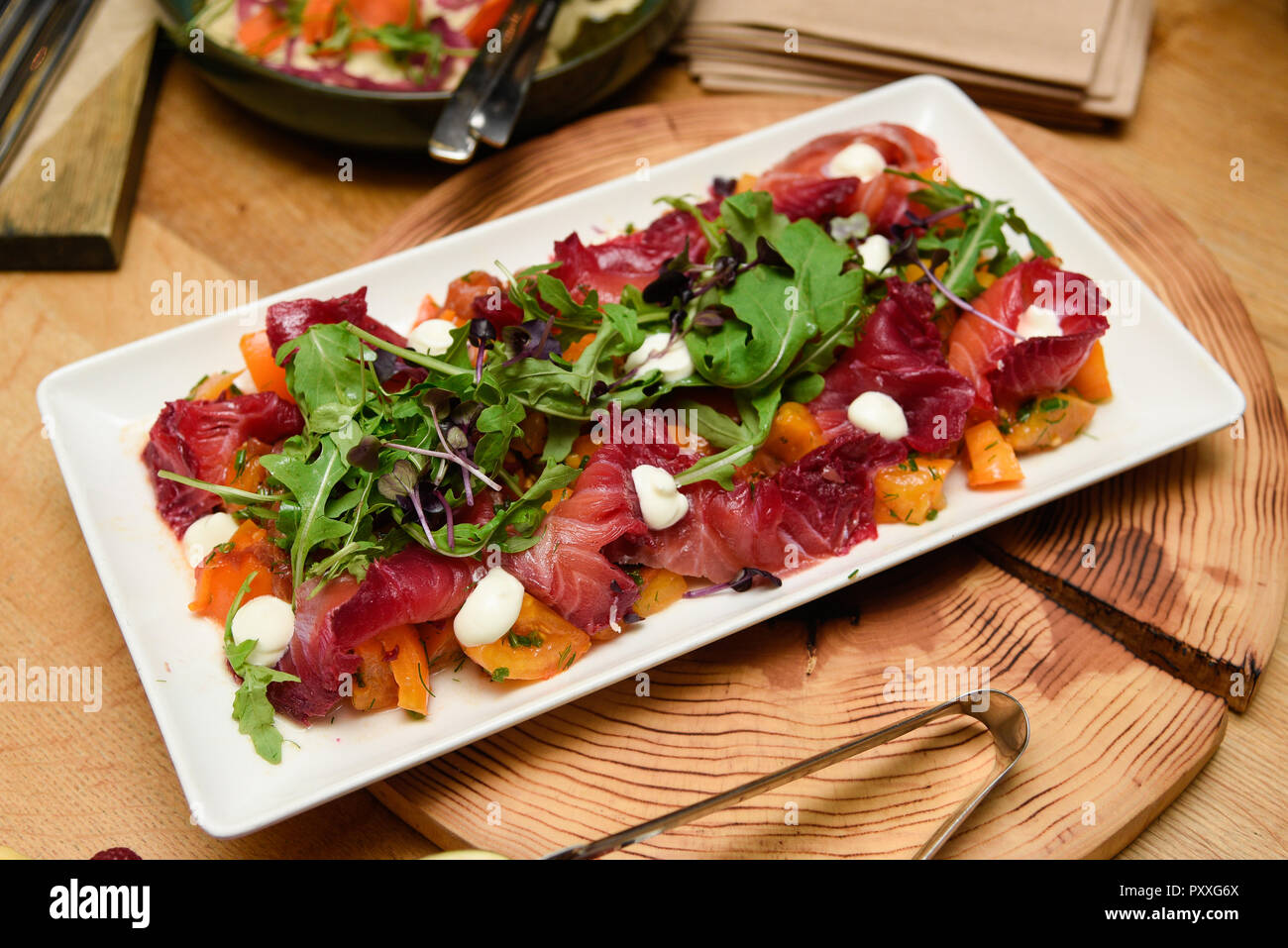 Smoked salmon salad plate with arugula leafs and mozzarella cheese. Stock Photo