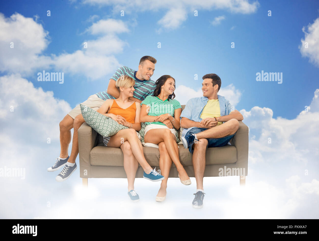 friends sitting on sofa over background Stock Photo - Alamy