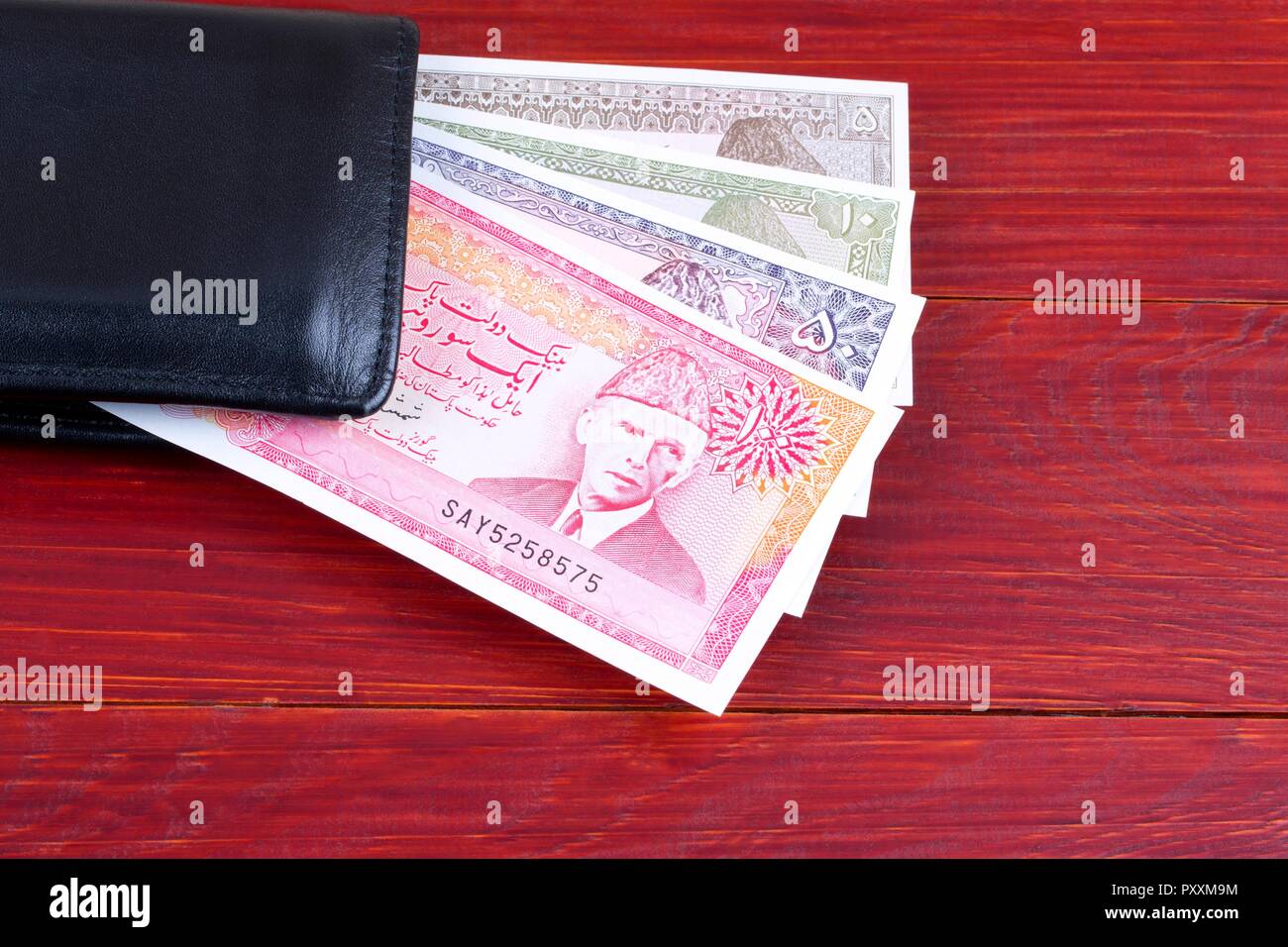 Old Pakistani money in the black wallet Stock Photo