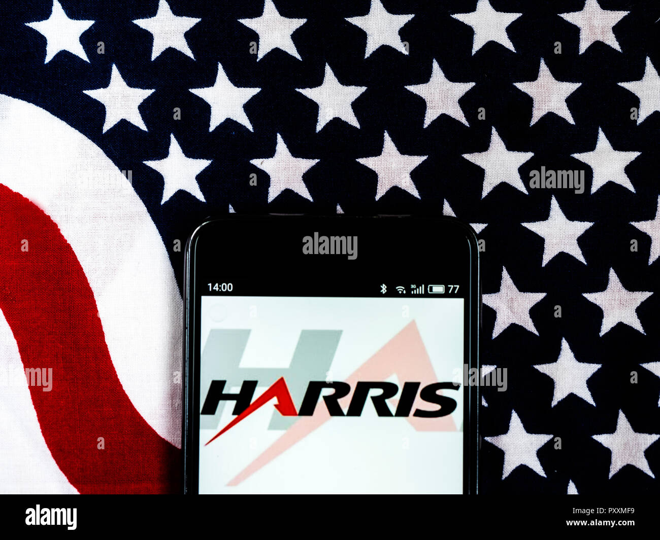 Harris Corporation Company logo seen displayed on smart phone.. Harris Corporation is an American technology company, defense contractor and information technology services provider that produces wireless equipment, tactical radios, electronic systems, night vision equipment and both terrestrial and spaceborne antennas for use in the government, defense and commercial sectors. Stock Photo