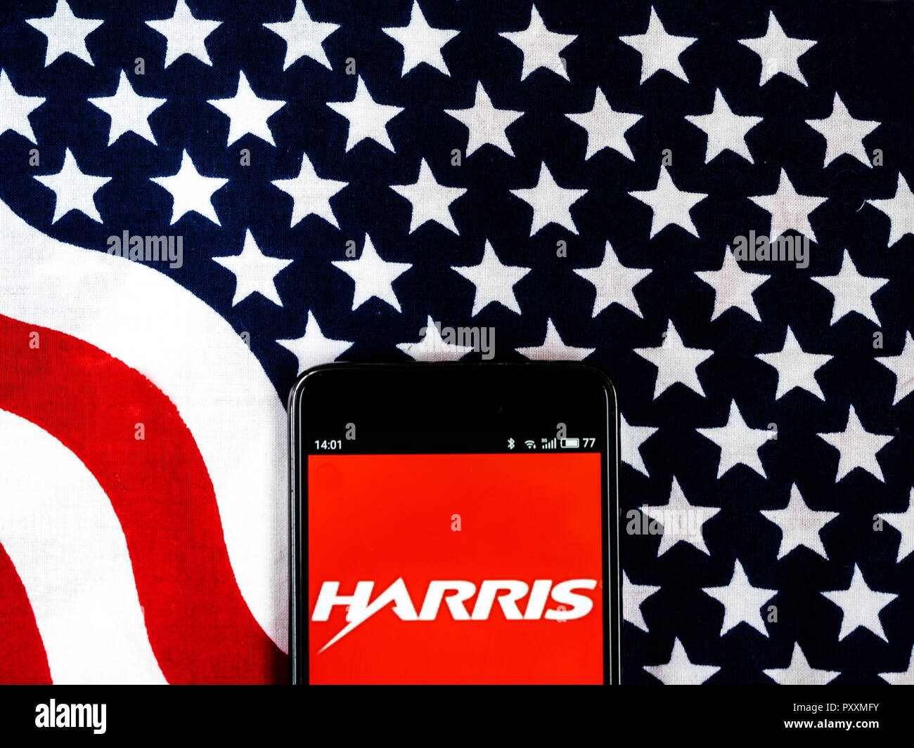 Harris Corporation Company logo seen displayed on smart phone.. Harris Corporation is an American technology company, defense contractor and information technology services provider that produces wireless equipment, tactical radios, electronic systems, night vision equipment and both terrestrial and spaceborne antennas for use in the government, defense and commercial sectors. Stock Photo