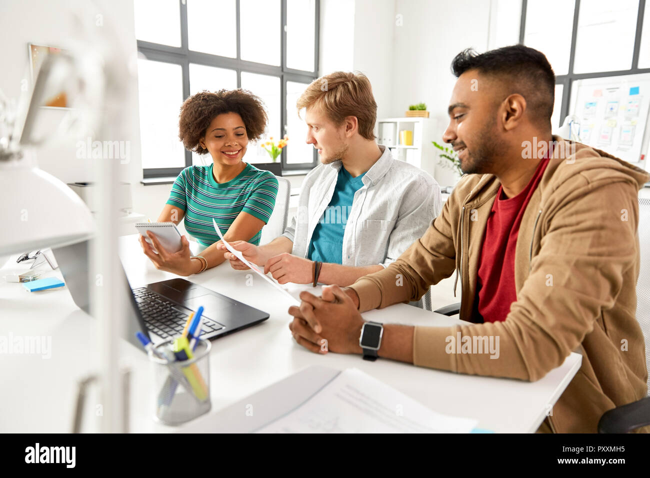 creative team discussing papers at office Stock Photo