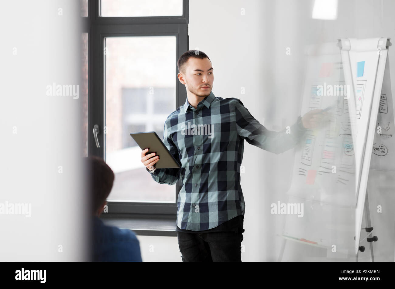 man showing tablet pc to creative team at office Stock Photo