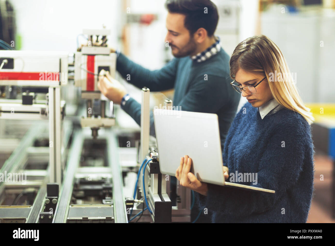 Young attractive students of mechatronics working on project Stock Photo