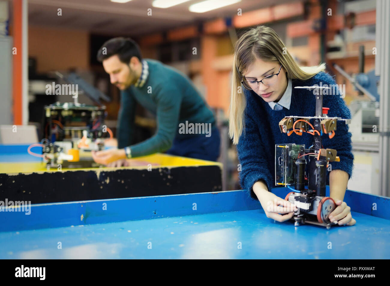 Young woman engineer working on robotics project Stock Photo