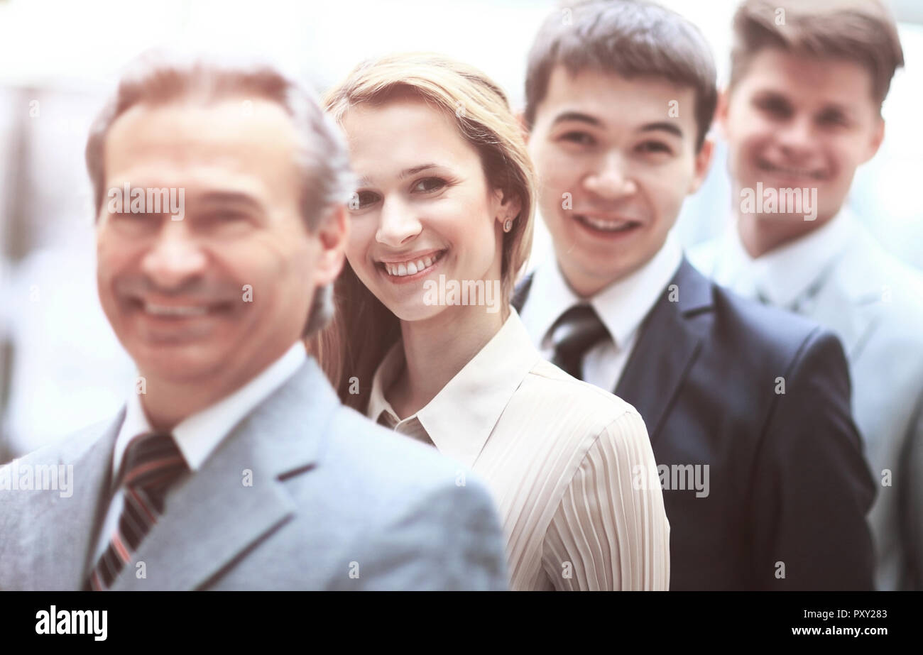 Happy smiling business team standing in a row at office Stock Photo - Alamy