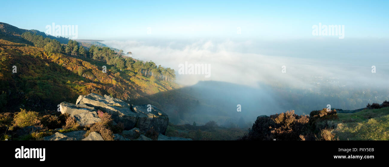 UK landscape panorama: mist rising over an autumnal Wharfedale Valley and Ilkley Moor creating a brocken spectre, West Yorkshire, UK Stock Photo