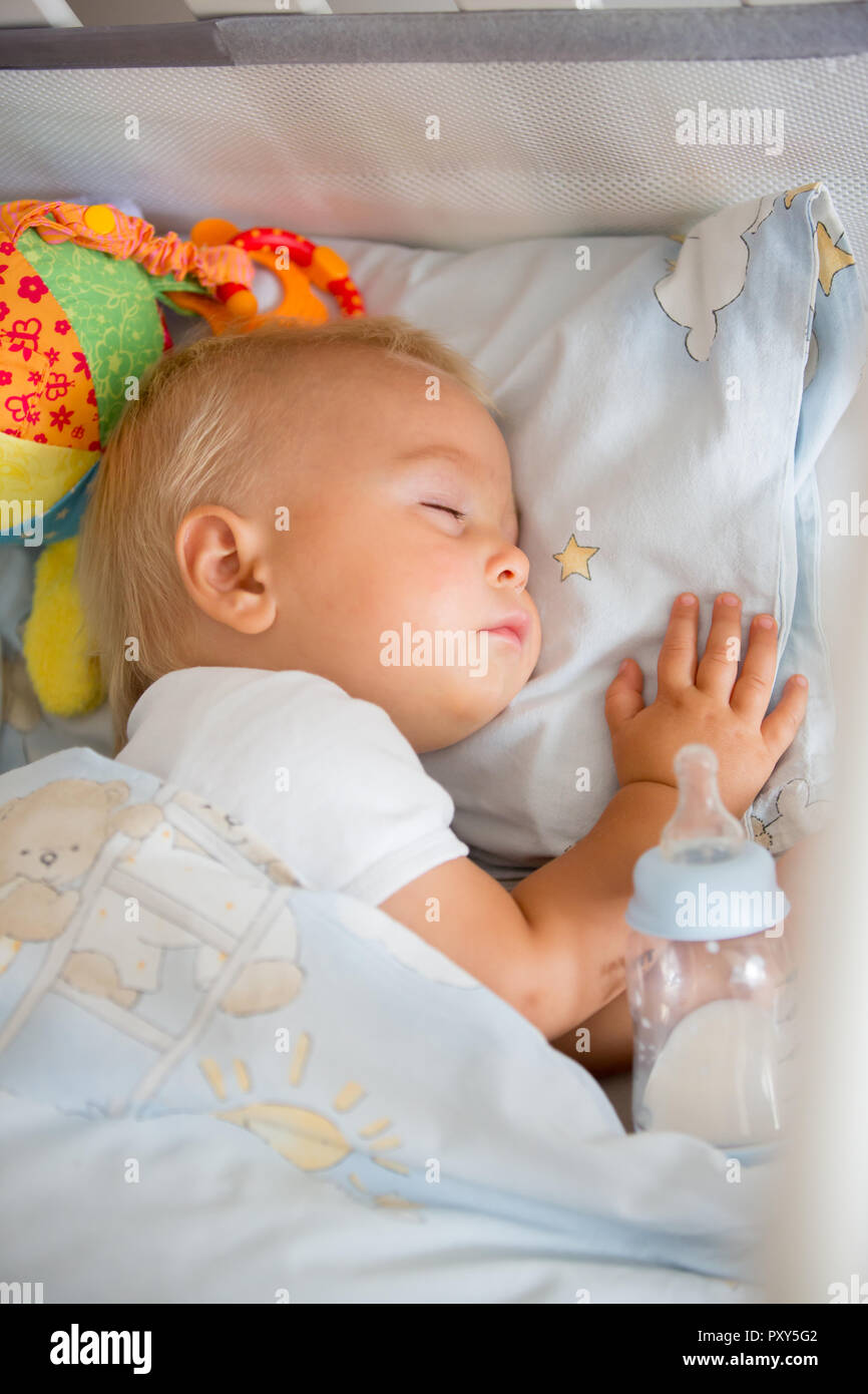 Cute Little Baby Boy Sleeping With Bottle With Formula Milk