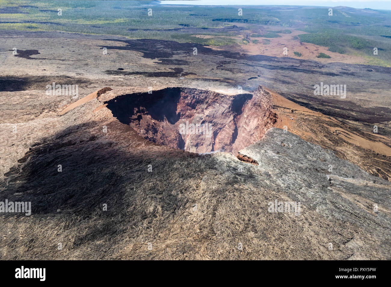 aerial view of Puu Ooo Volcanic cone on the Big Island of Hawaii. Volcanic gas can be seen escaping from the crater. Stock Photo